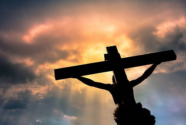 A cross silhouetted against the sky